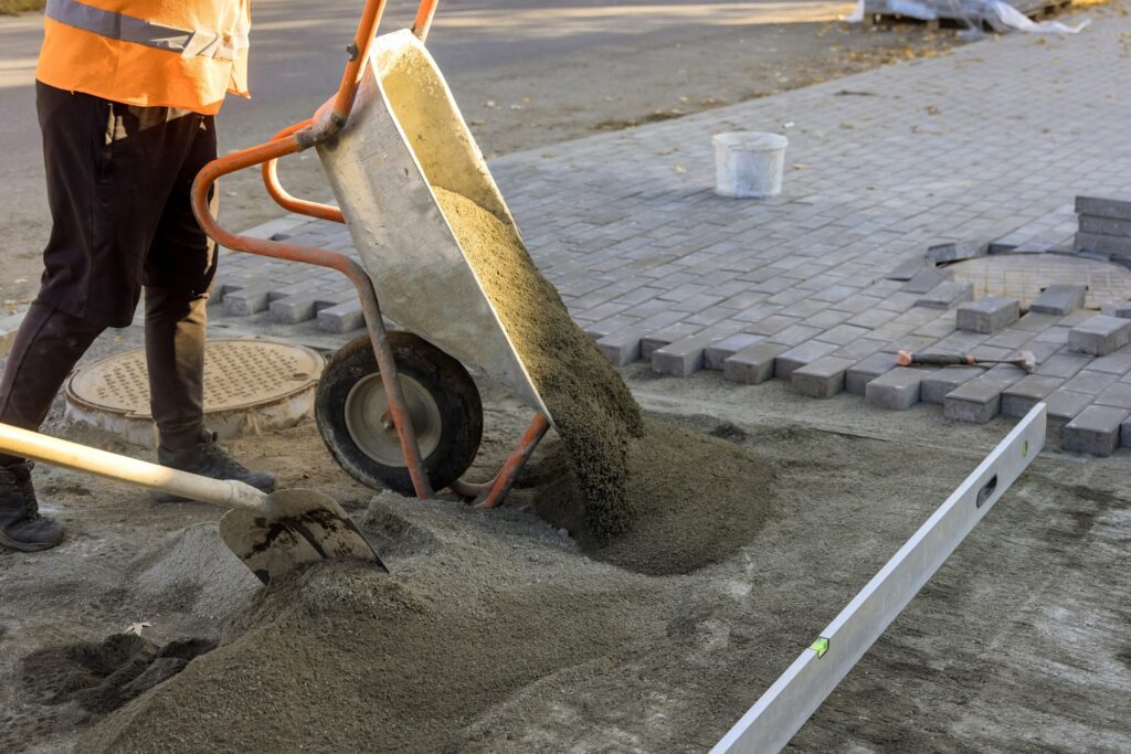 Road construction works with preparation of the surface to establish sidewalk bricks of sandy sand